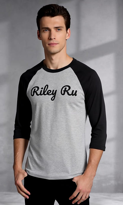 Man wearing a gray and black 'Riley Ru' baseball shirt against a neutral background