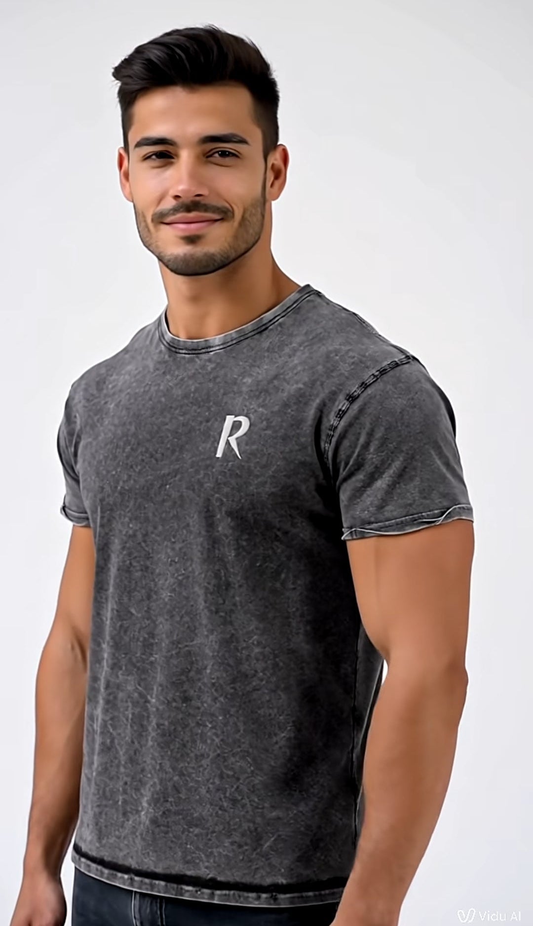 Man wearing a dark gray t-shirt with a white logo on a white background