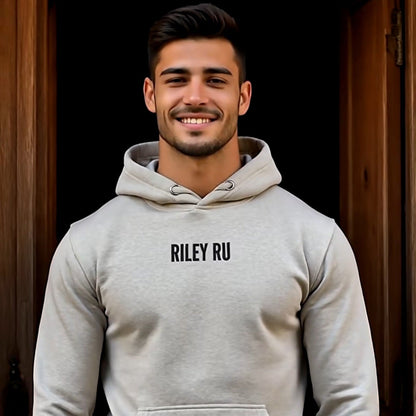 Man wearing a gray hoodie with 'RILEY RU' branding against a dark background