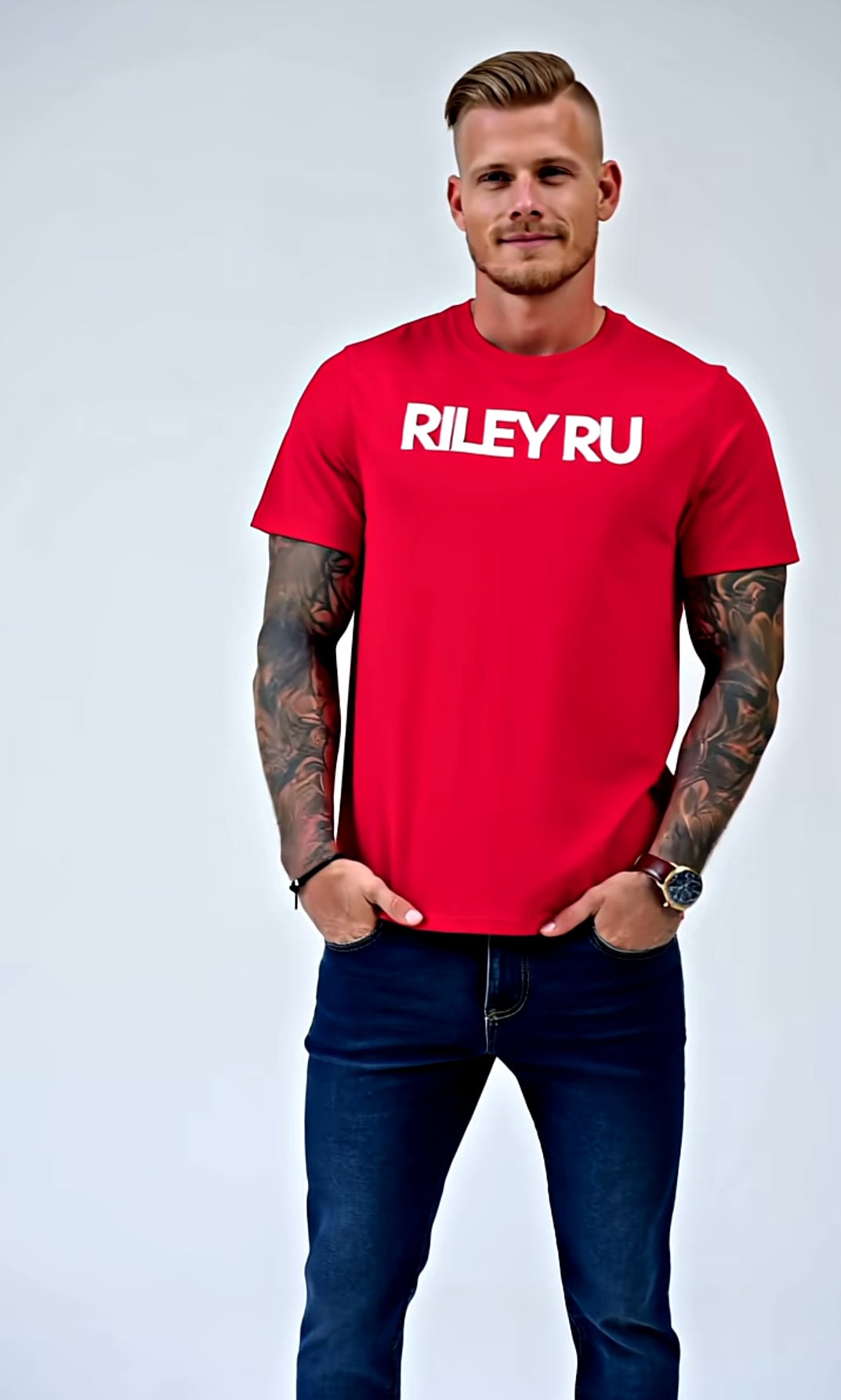 Man wearing a red 'RILEY RU' t-shirt against a light gray background
