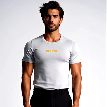 Man wearing a white t-shirt with yellow text and black pants on a light gray background