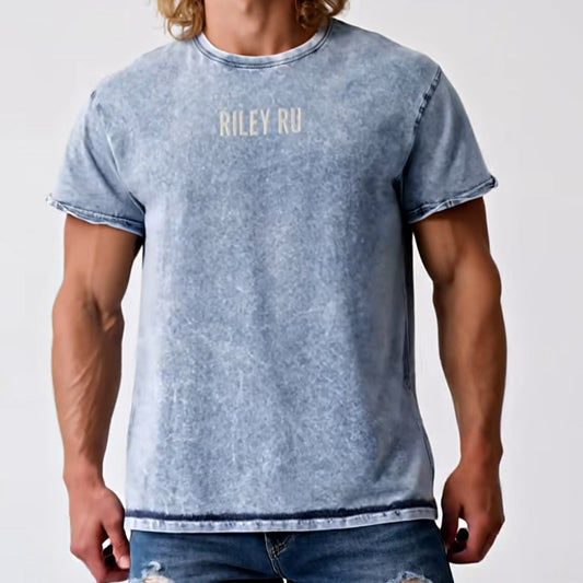 Man wearing a blue t-shirt with 'Riley RU' branding and ripped jeans on a white background