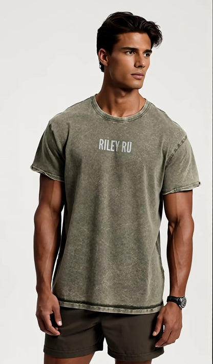 Man wearing a green t-shirt with 'RILEY RU' text on a white background