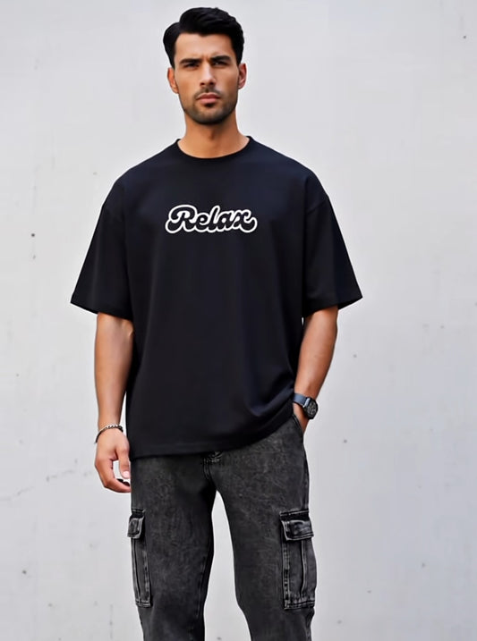 Man wearing a black t-shirt with 'Relax' text against a gray background