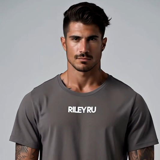 Man wearing a gray t-shirt with 'RILEYRU' logo on a gray background