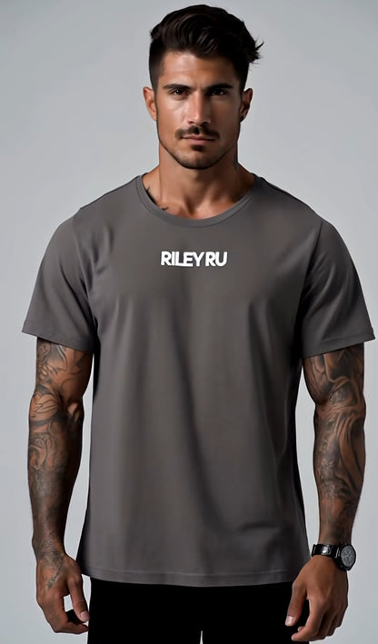Man wearing a gray t-shirt with 'RILEYRU' logo on a gray background