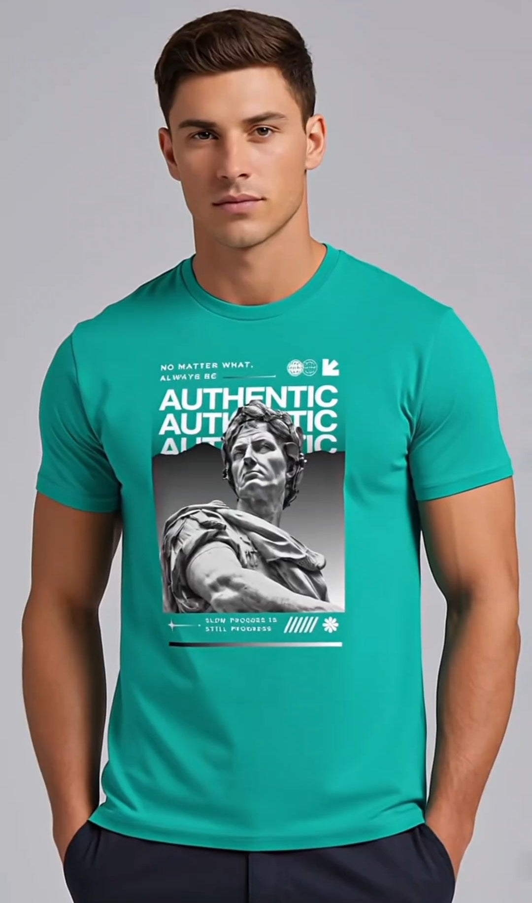 Man wearing a teal t-shirt with a graphic design on a gray background