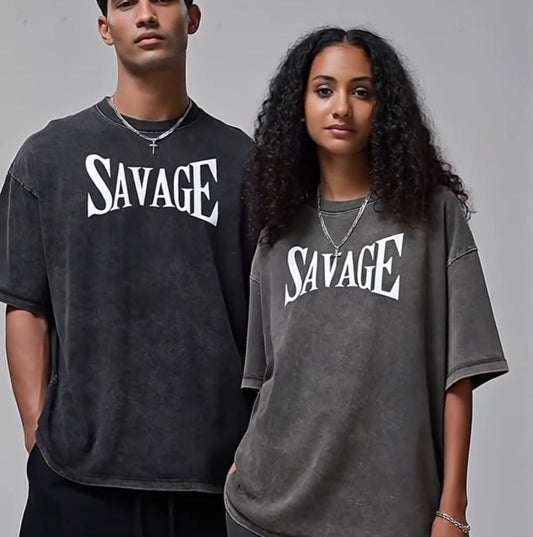 Two people wearing 'SAVAGE' t-shirts standing against a plain background
