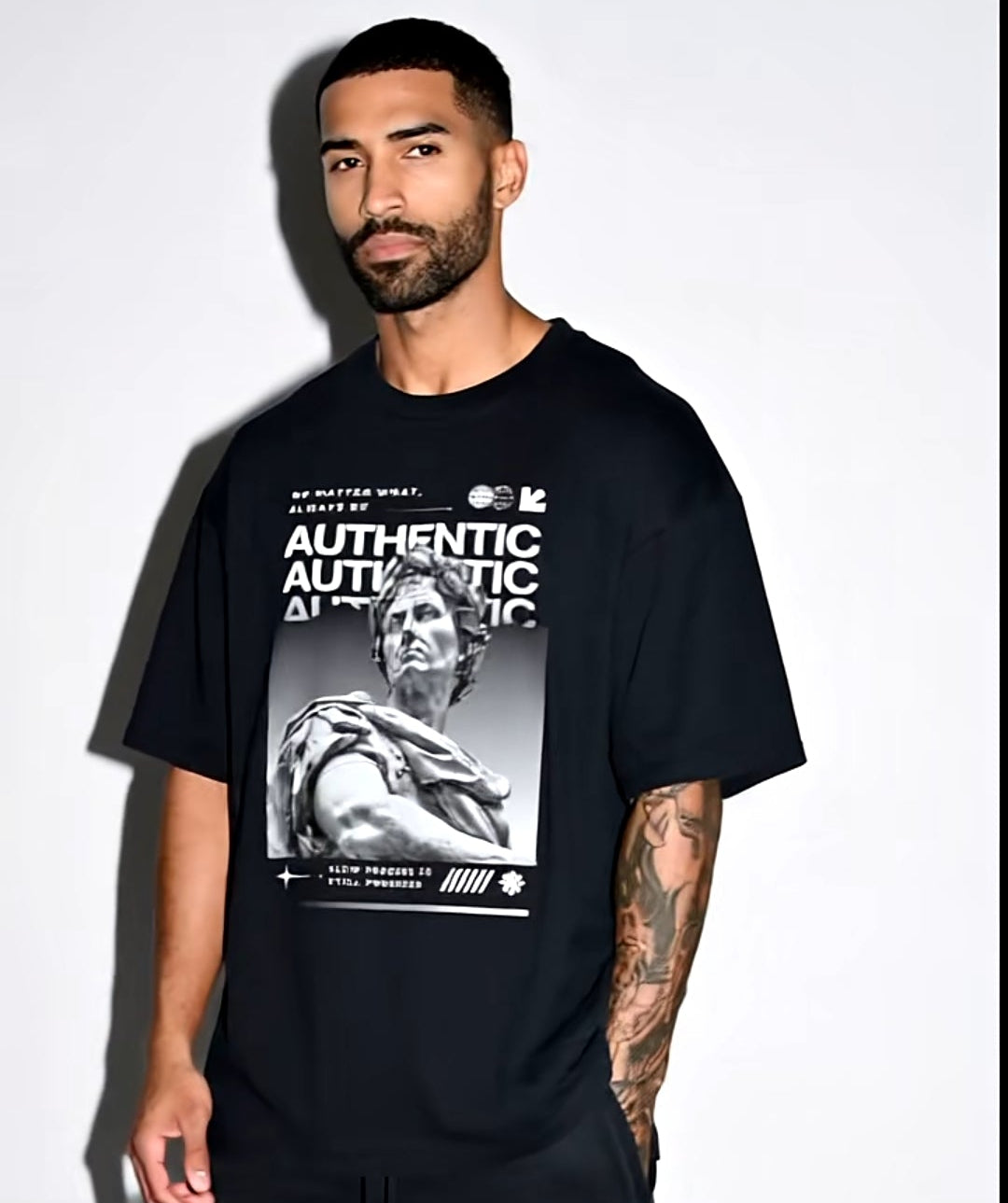 Person wearing a black t-shirt with graphic design on a white background