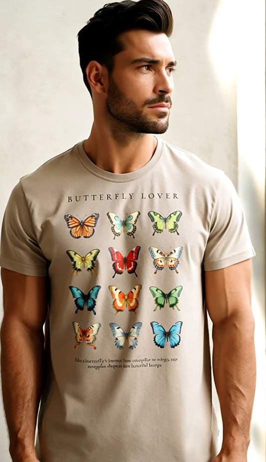 Man wearing a beige t-shirt with butterfly designs and text.