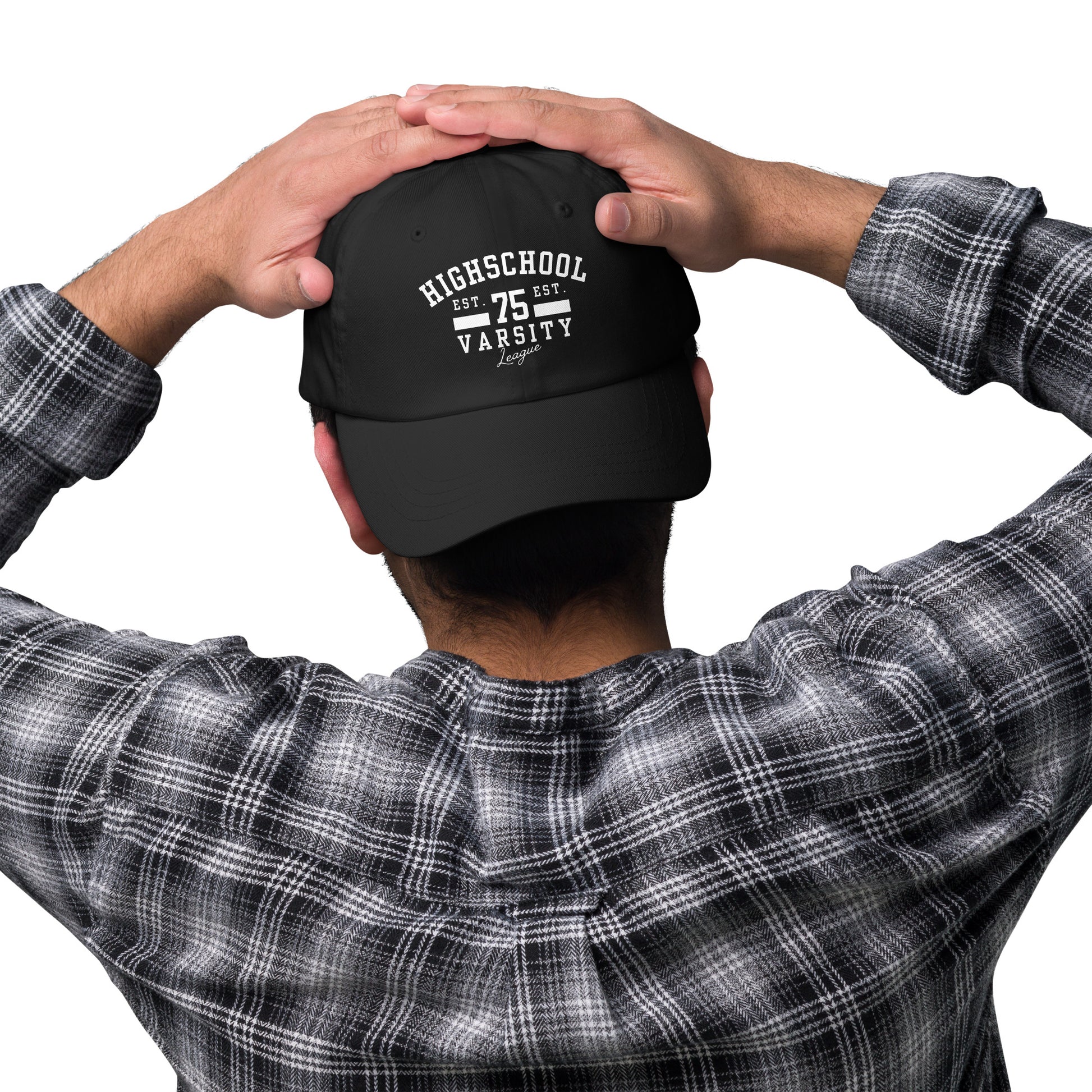 Person wearing a black cap with 'HIGH SCHOOL VARSITY' on a white background