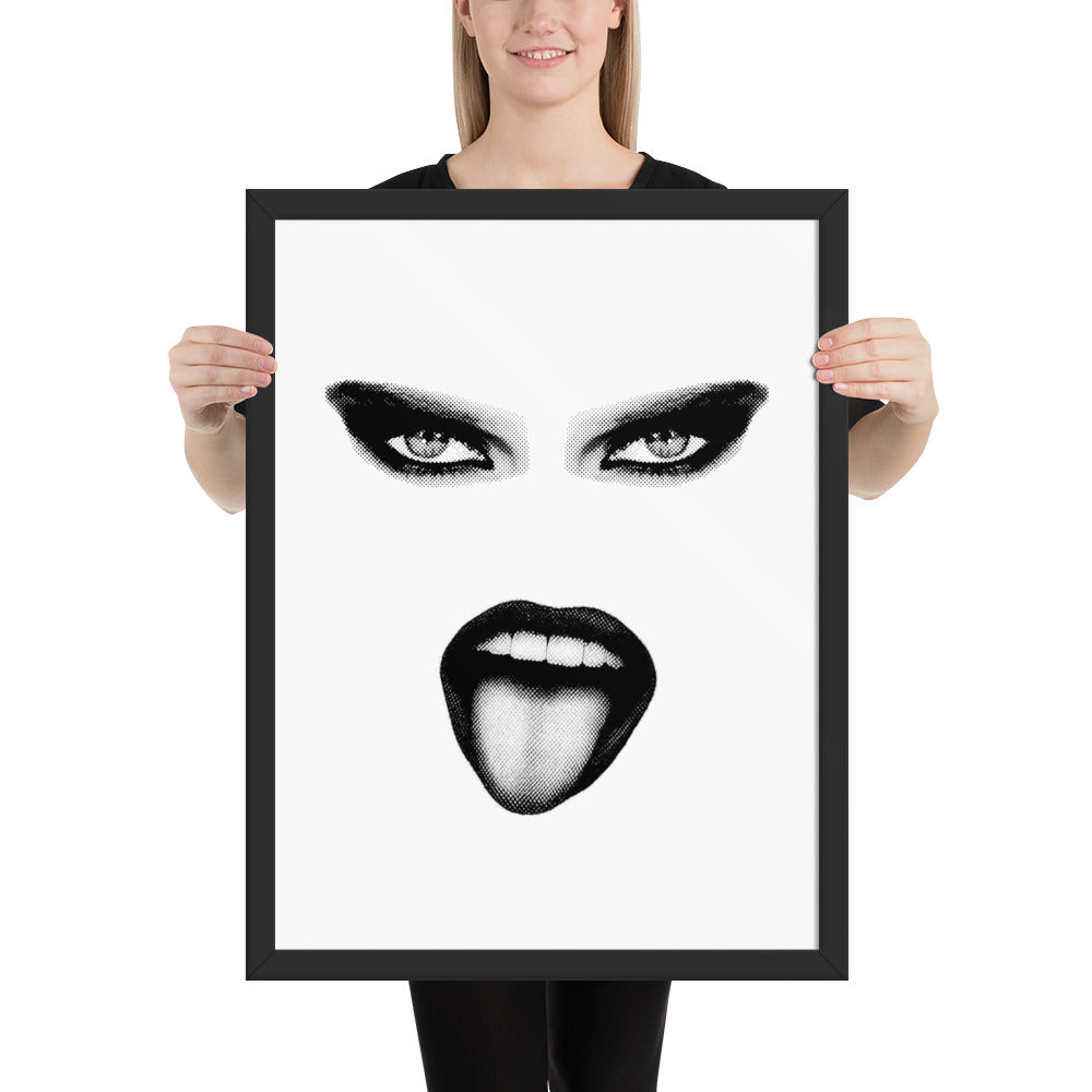Person holding a framed artwork of a stylized face with black eyes and lips on a white background