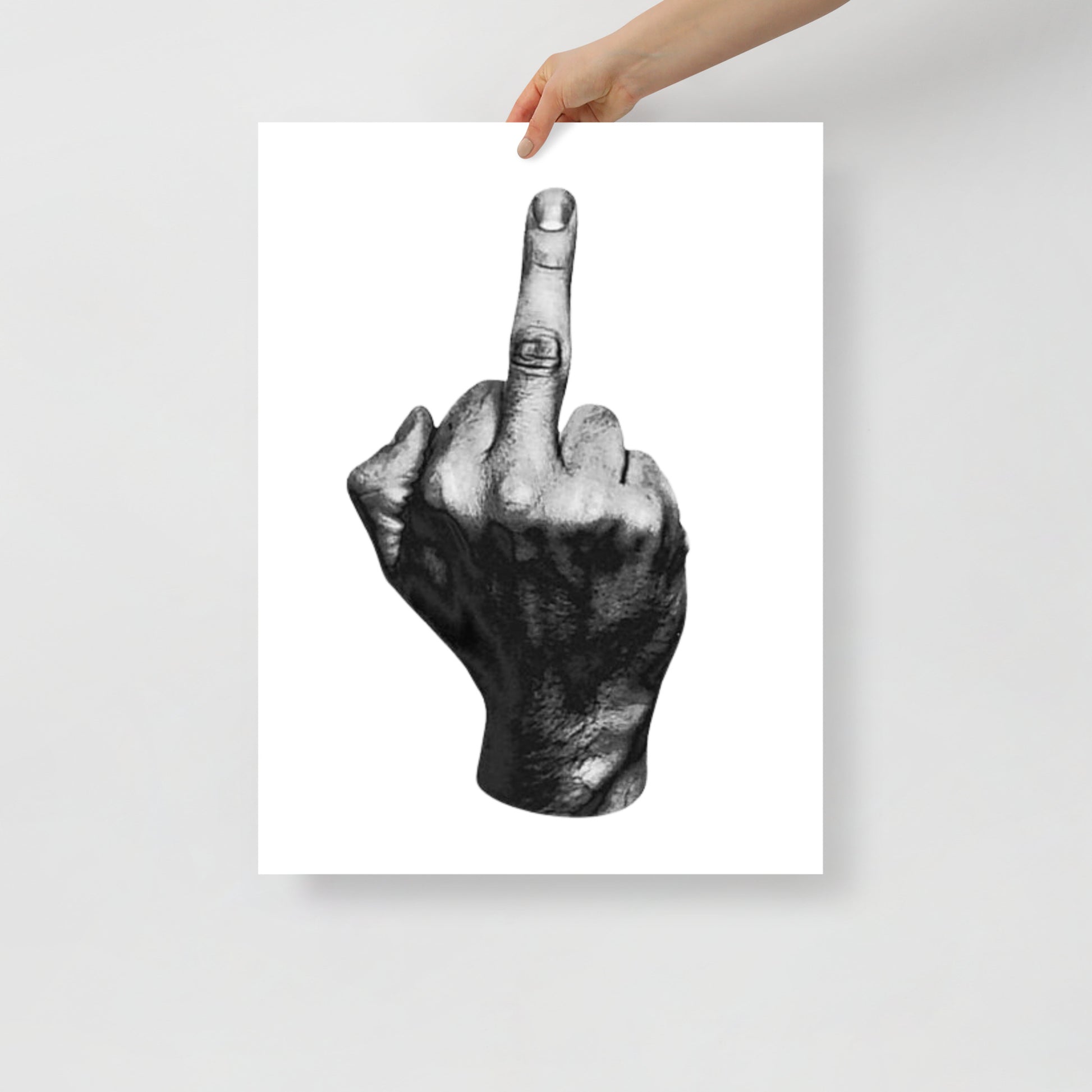 Hand holding a poster of a black and white illustration of a hand with the middle finger raised.