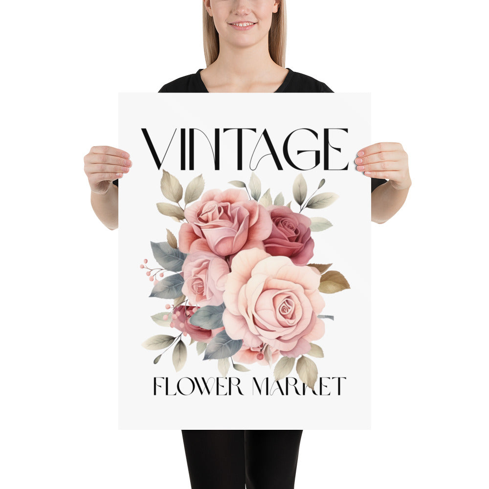 Person holding a poster with floral design and 'Vintage Flower Market' text