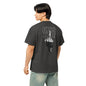 Person wearing a black t-shirt with a logo on the back, standing against a white background
