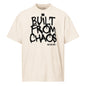 Beige t-shirt with 'Built from Chaos' text on a white background