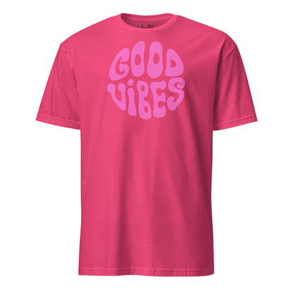Pink t-shirt with 'Good Vibes' text on a white background