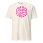 White t-shirt with pink 'Good Vibes' text on a white background