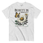 Gray t-shirt with a graphic of flowers and a butterfly, featuring the text 'Beauty in Simplicity'.