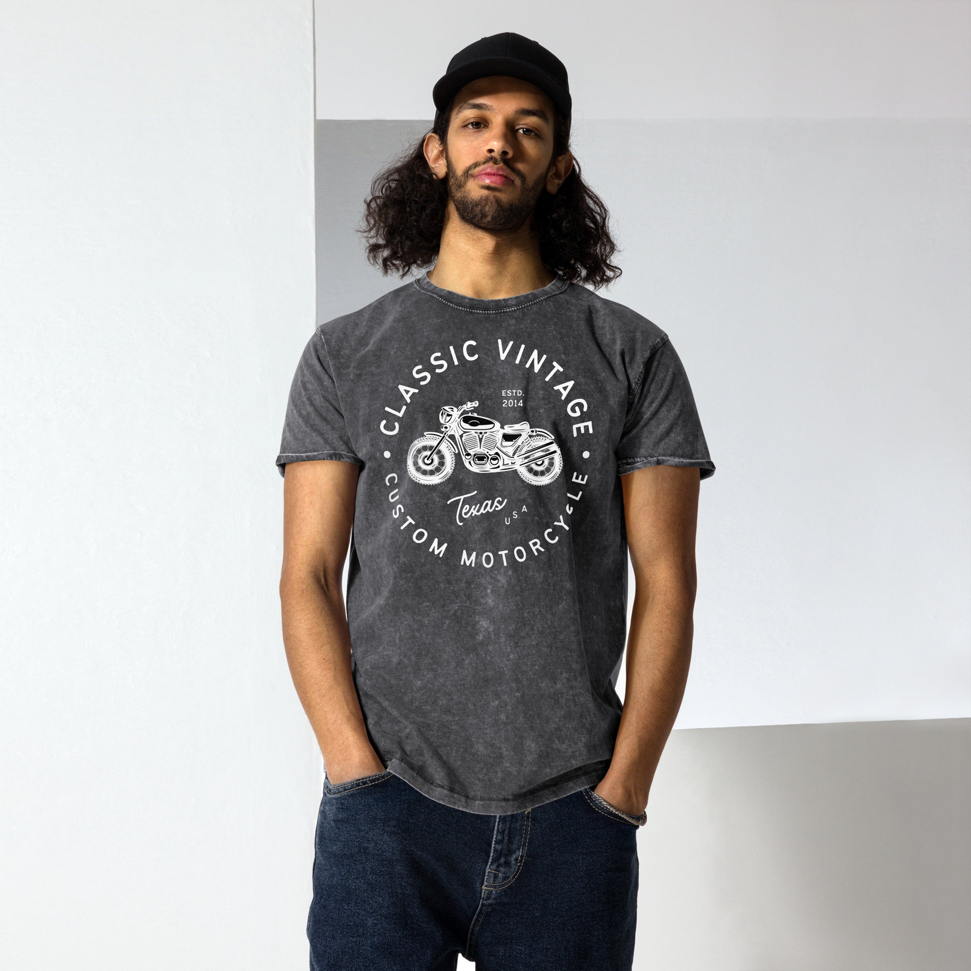 Man wearing a dark gray t-shirt with a motorcycle graphic and text.