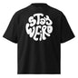 Black t-shirt with 'Stay Weird' text on a white background