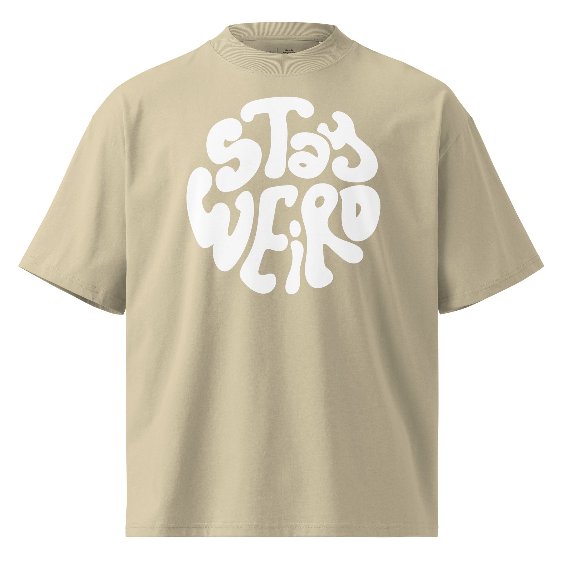 Beige t-shirt with 'Stay Weird' text in white on a white background