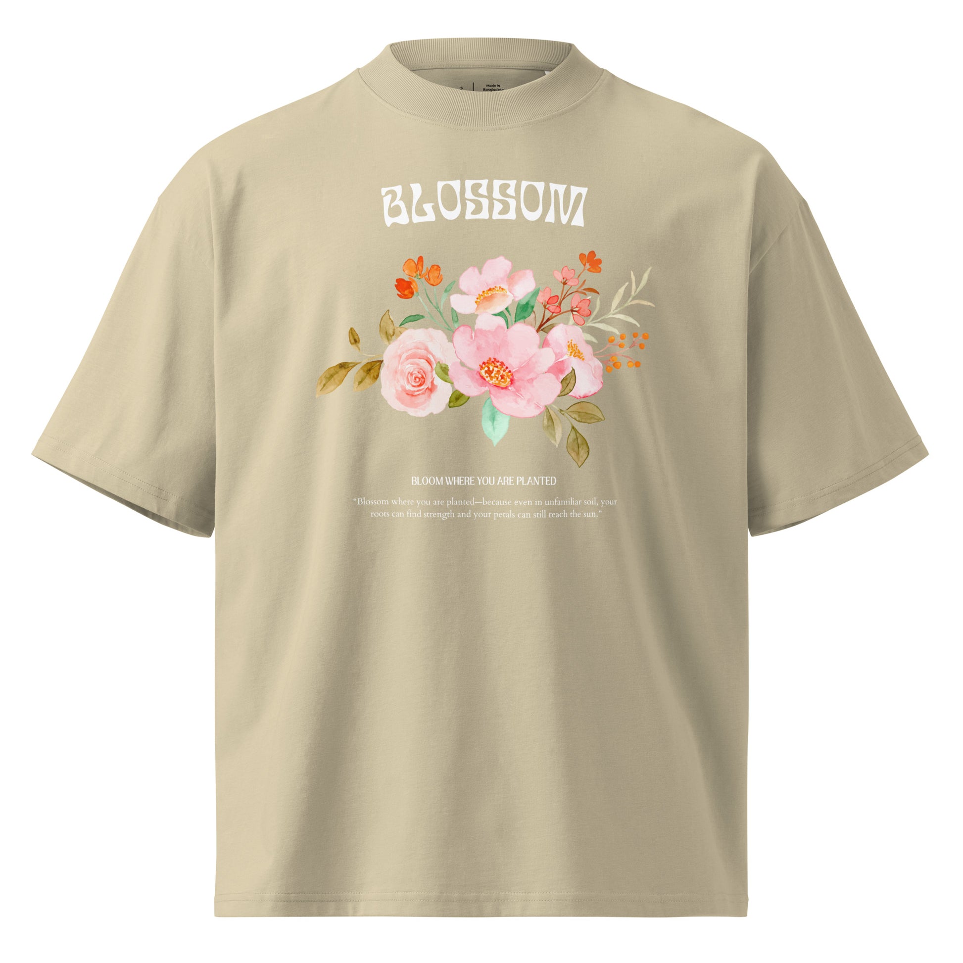 Beige t-shirt with floral design and 'Blossom' text on a white background