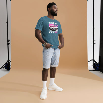 Man wearing a blue t-shirt with a graphic design, light shorts, and white sneakers in a studio setting.